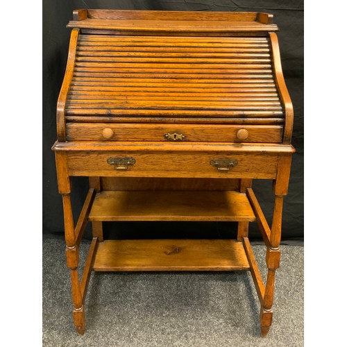 100 - A late 19th century oak tambour-top desk, of small proportions, galleried top, pigeon-hole fitted in... 