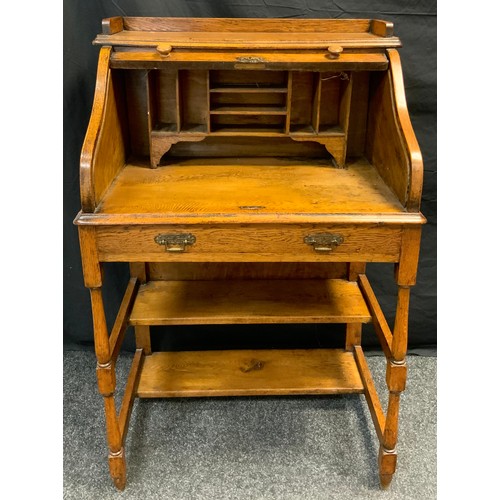 100 - A late 19th century oak tambour-top desk, of small proportions, galleried top, pigeon-hole fitted in... 