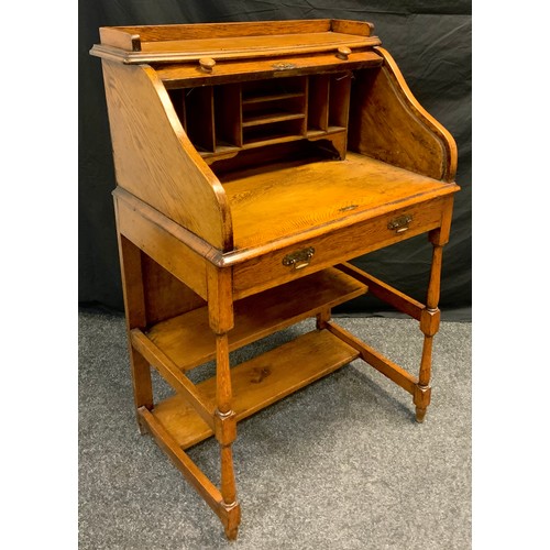 100 - A late 19th century oak tambour-top desk, of small proportions, galleried top, pigeon-hole fitted in... 