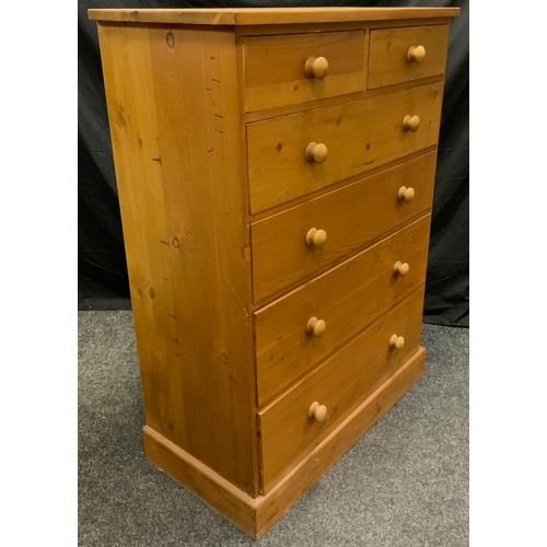 308 - A 20th century pine chest of drawers, two short over four graduated long drawers, turned handles, 12... 