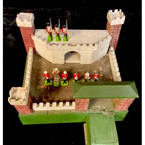 914 - Toys & Juvenalia - a 1950's wooden toy fort; three boxes of Steadfast model soldiers