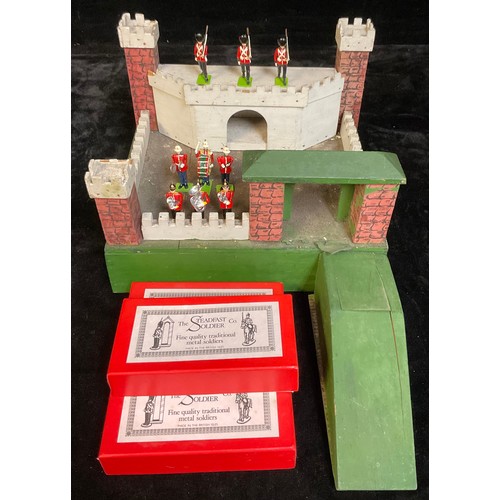 914 - Toys & Juvenalia - a 1950's wooden toy fort; three boxes of Steadfast model soldiers