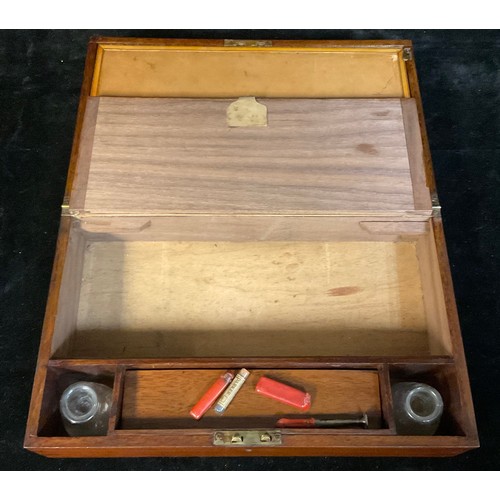 963 - A late Victorian mahogany folding writing slope, tan leather writing surface, pair of glass inkwells... 