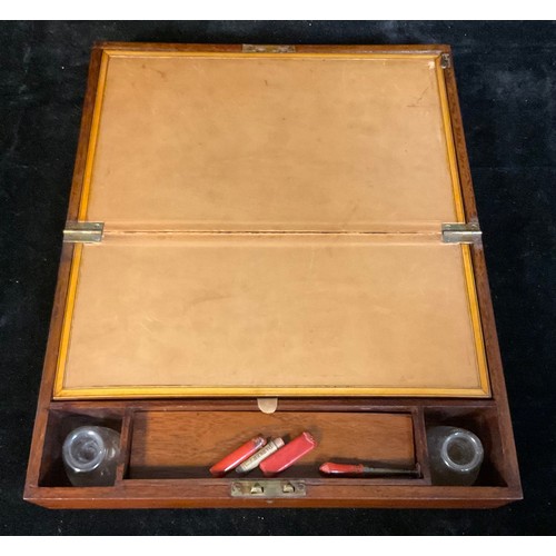 963 - A late Victorian mahogany folding writing slope, tan leather writing surface, pair of glass inkwells... 