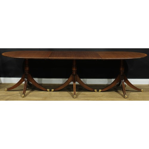 1 - A Regency style mahogany triple-pillar dining table, discorectangular top with reeded edge and two a... 