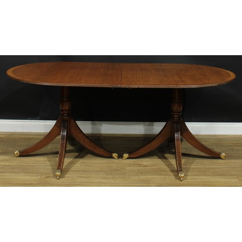 1 - A Regency style mahogany triple-pillar dining table, discorectangular top with reeded edge and two a... 