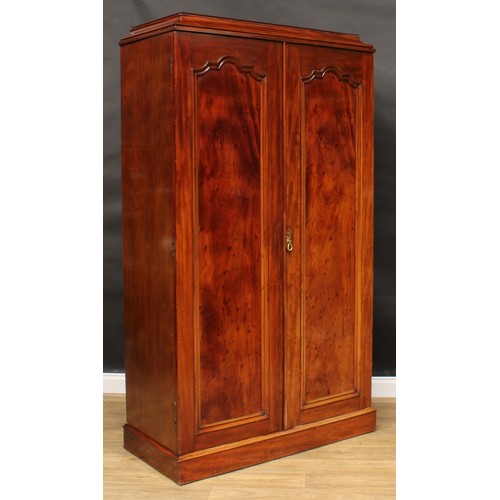 10 - A 19th century mahogany press cupboard, moulded cornice above a pair of panel doors enclosing three ... 