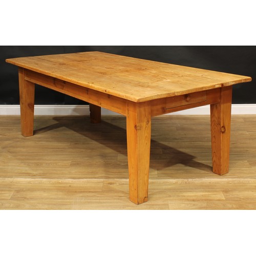 12 - A large pine farmhouse kitchen table, 78cm high, 216.5cm long, 109cm wide