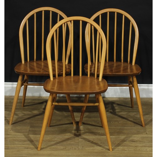 104 - A set of three Ercol beech and elm 2056 Windsor dining chairs, 83cm high, 42.5cm wide, the seat 34cm... 