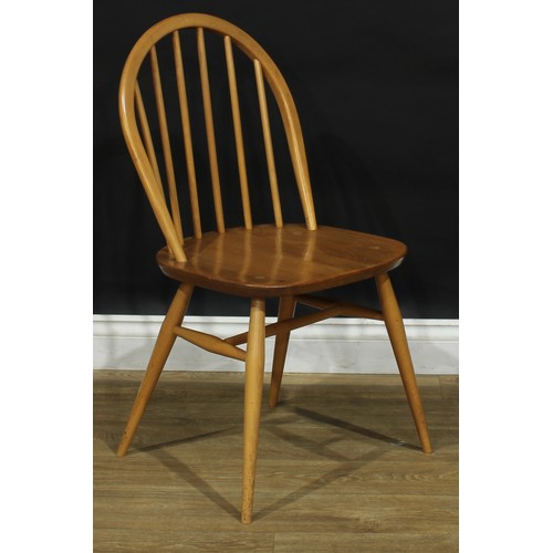 104 - A set of three Ercol beech and elm 2056 Windsor dining chairs, 83cm high, 42.5cm wide, the seat 34cm... 