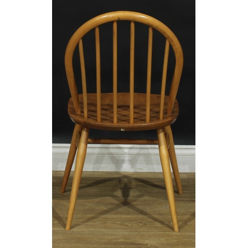 104 - A set of three Ercol beech and elm 2056 Windsor dining chairs, 83cm high, 42.5cm wide, the seat 34cm... 