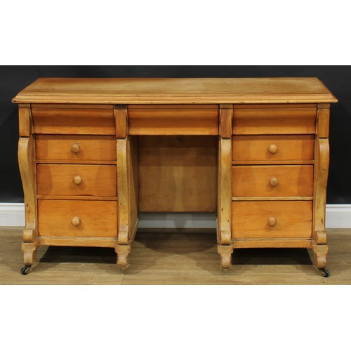 105 - A late 19th/early 20th century pine kneehole desk, rectangular top with moulded edge above an arrang... 