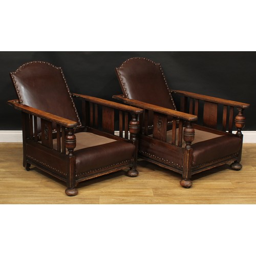 113 - A pair of early 20th century oak reclining club armchairs, 94cm high, 73cm wide, c.1930 (2)