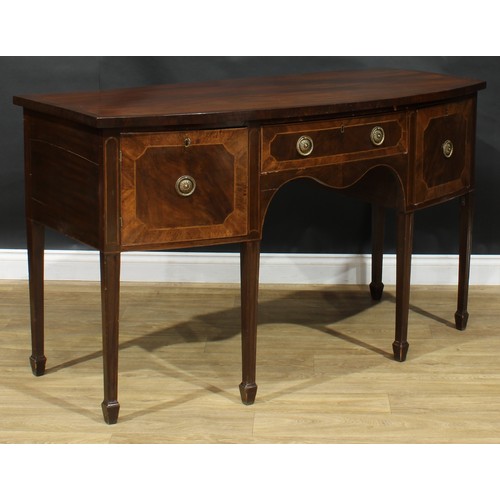 115 - A George III Revival mahogany bowfront serving table or sideboard, oversailing top above a central f... 