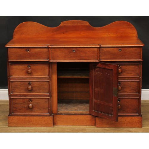 119 - A Victorian mahogany break-centre kneehole bedroom desk or side cabinet, oversailing top above three... 