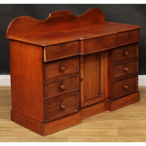 119 - A Victorian mahogany break-centre kneehole bedroom desk or side cabinet, oversailing top above three... 