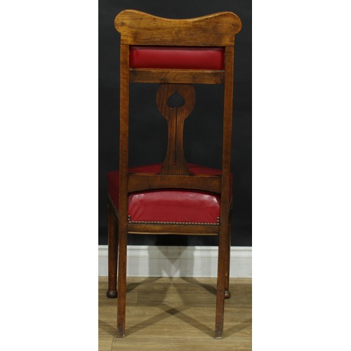 215 - A set of four Arts & Crafts period oak dining chairs, each with a shaped splat pierced in the Art No... 