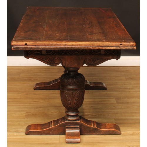 218 - An Elizabethan design oak draw-leaf dining table, rectangular top with two sliding leaves, above a f... 