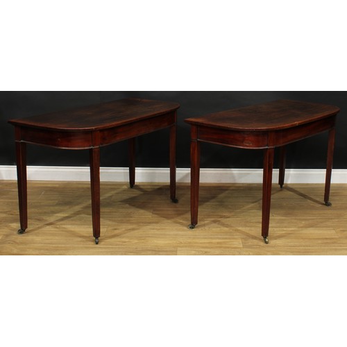 306 - A pair of George III mahogany D-shaped side tables or serving tables, formerly the end sections of a... 