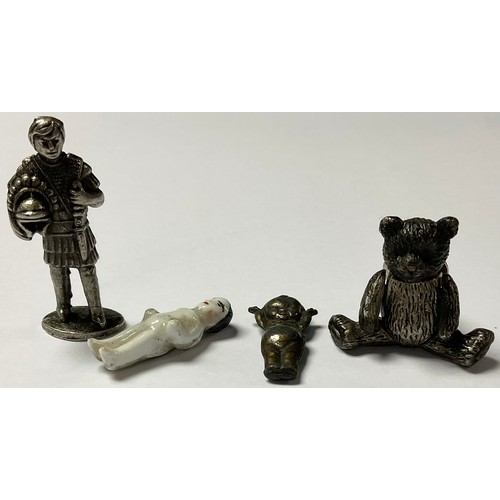 1148 - A miniature articulated teddy bear brooch; a miniature model, of a Roman soldier; a porcelain doll; ... 