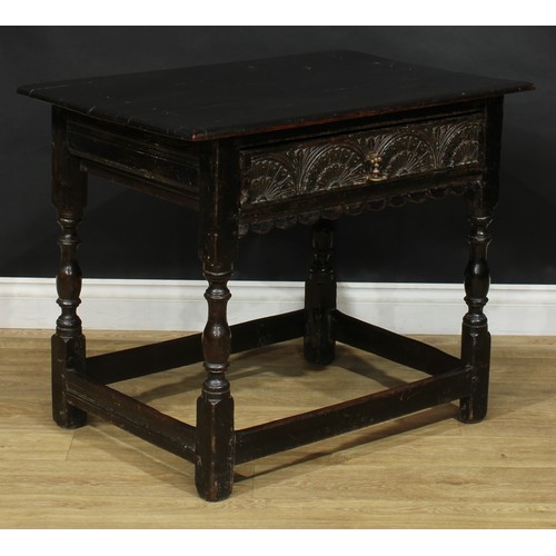 310 - An oak side table, rectangular top above a long lunette carved frieze drawer, shaped apron, turned a... 