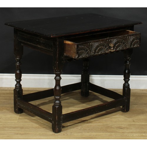 310 - An oak side table, rectangular top above a long lunette carved frieze drawer, shaped apron, turned a... 