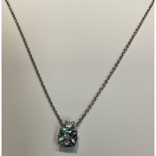 1176 - A silver and cubic zirconia pendant necklace, the large facet cut stone suspended from a smaller sto... 