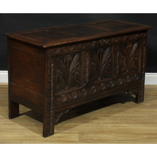 402 - A late 17th century style oak fall front blanket chest, the front carved throughout with stylised fl... 