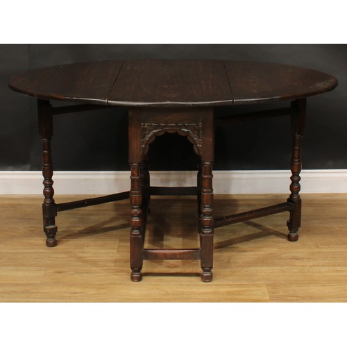 410 - An oak gateleg table, 73cm high, 51cm opening to 137cm long, 107cm wide; a set of six similar dining... 