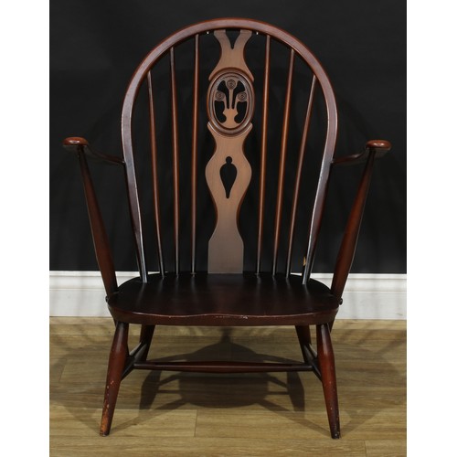 415 - An Ercol Fleur De Lys low armchair, Old Colonial range, 81.5cm high, 70cm wide, the seat 46cm wide a... 