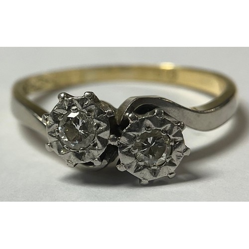 1187 - An 18ct gold and platinum two stone diamond crossover ring