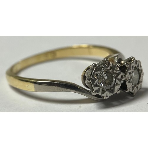 1187 - An 18ct gold and platinum two stone diamond crossover ring