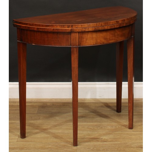 804 - A George III mahogany demilune card table, 73cm high, 84cm wide, 41cm deep