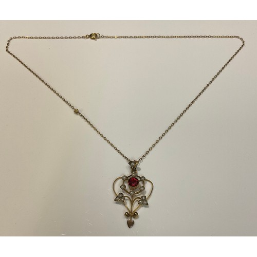 1191 - An Edwardian gold coloured metal, garnet and seed pearl pendant necklace