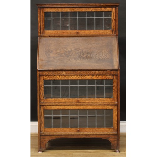 814 - An early 20th century oak Globe Wernicke type lead glazed bureau bookcase, 139.5cm high, 80cm wide, ... 