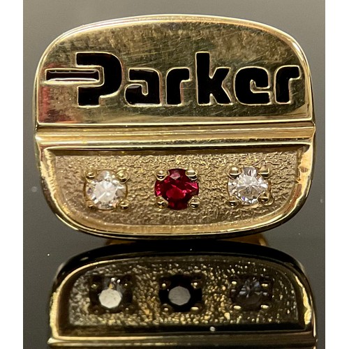 1199 - A 9ct gold pin badge, Parker employee award, set with a ruby chip flanked by a pair of diamond chips... 