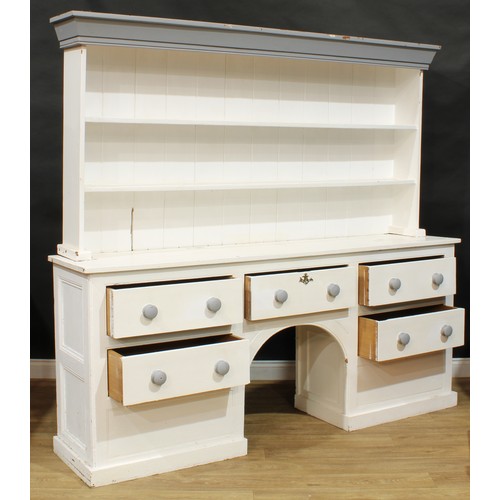 10A - A late 19th/early 20th century painted pine dog kennel dresser, moulded cornice above a pair of plat... 