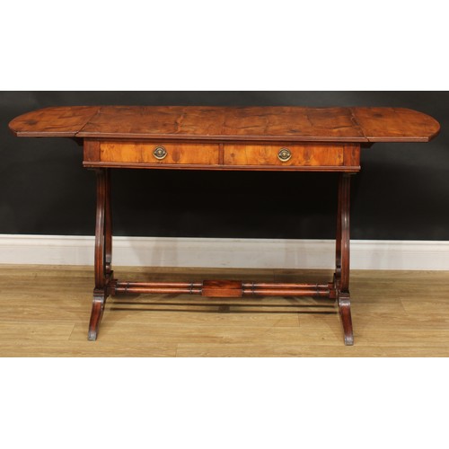 801 - A Regency style yew veneer and mahogany sofa table, discorectangular top with fall leaves above a pa... 