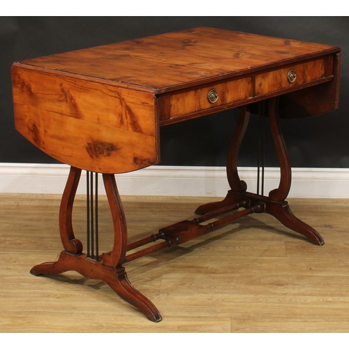 801 - A Regency style yew veneer and mahogany sofa table, discorectangular top with fall leaves above a pa... 