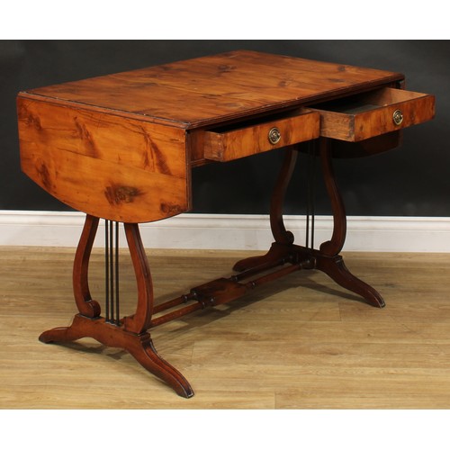 801 - A Regency style yew veneer and mahogany sofa table, discorectangular top with fall leaves above a pa... 