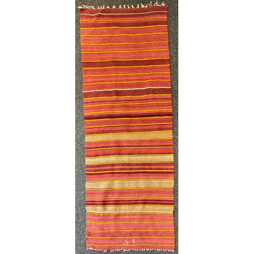 1284 - A Turkish woollen rug/runner, in bands of red, orange and ochre, 79cm wide, 208cm long