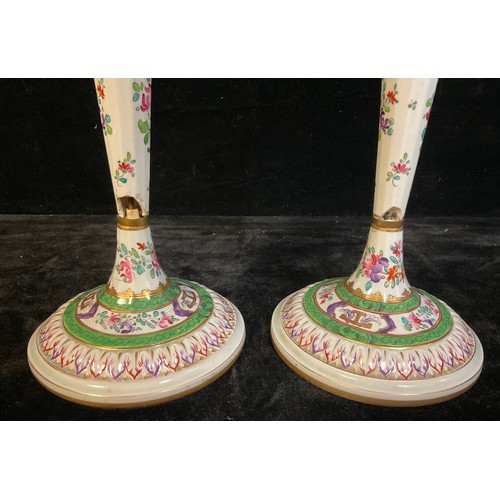 395A - A pair of 18th century Chinese Export table candlesticks, painted in the Famille Verte palette, face... 