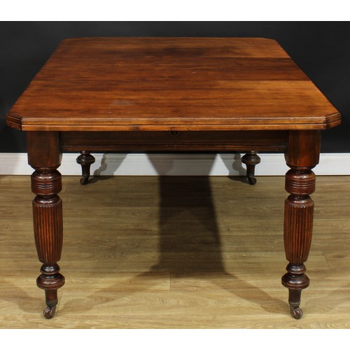 105A - A late Victorian/Edwardian extending dining table, chamfered rectangular top with one additional lea... 