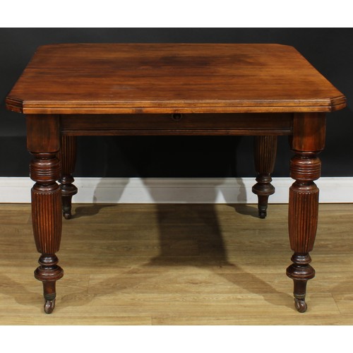 105A - A late Victorian/Edwardian extending dining table, chamfered rectangular top with one additional lea... 