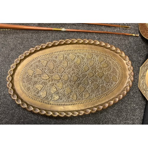 67 - A pair of early 20th century oval brass trays, embossed Ivy leaf and Berries decoration, each measur... 