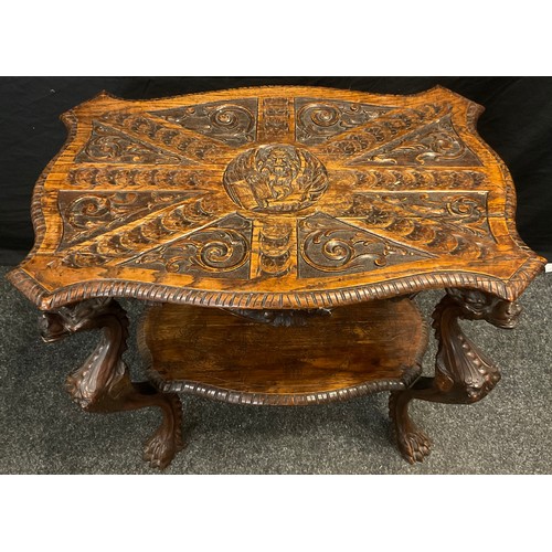 72 - An Italianate carved oak centre table, shaped top, carved with a book with text Pax Evan, Ti Bi Geli... 