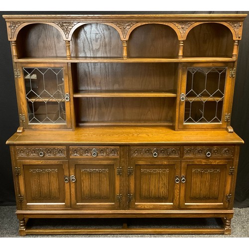 82 - An Old Charm oak dresser, ‘Sovereign’ model, leaded glass cupboard doors to top, with two tiers of s... 