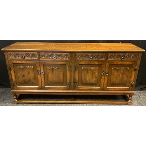 82 - An Old Charm oak dresser, ‘Sovereign’ model, leaded glass cupboard doors to top, with two tiers of s... 