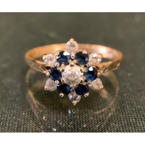 423 - A 9ct gold cz and sapphire effect floral cluster ring, size N, 2.2g gross