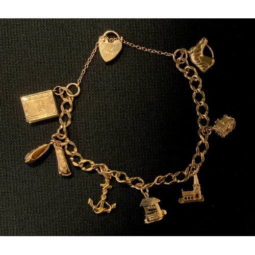 427 - A 9ct gold fancy link charm bracelet, suspending seven charms including Anchor, Treasure chest, pair... 